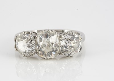 Lot 105 - A platinum diamond three stone old oval cut mounted dress ring