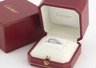 Lot 138 - A platinum and diamond Cartier cased and certificated half hoop eternity ring