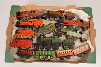 Lot 715 - An assortment of 'Cheap End' O Gauge clockwork Trains by Brimtoy with Floor trains by Whitanco and others (17)