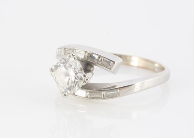Lot 211 - An 18ct gold diamond solitaire cross over ring