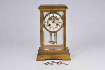 Lot 68 - An Edwardian brass and glazed mantle clock
