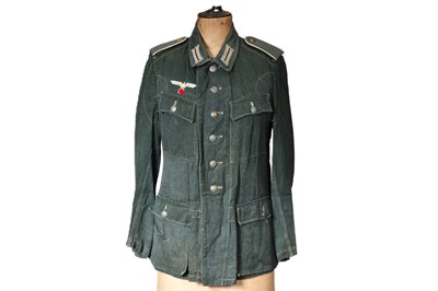 Lot 323 - A WWII German Army green herringbone twill Tunic