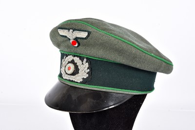 Lot 394 - A WWII German Heer 2nd Type Officer's peaked Cap