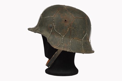 Lot 409 - A WWII M42 Raw Edge Steel Helmet