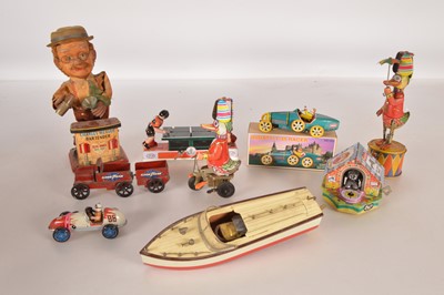 Lot 523 - Collection of mostly modern Chinese mechanical Tin Toys together with Japanese Battery operated Charley Weaver and small wooden launch with electric motor (9)