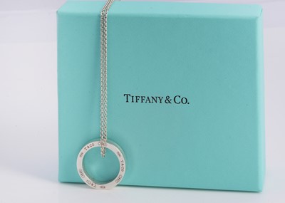 Lot 64 - A silver Tiffany & Co circle band pendant necklace, in turquoise box marked Tiffany & Co