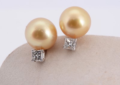 Lot 93 - A pair of golden south sea pearl & diamond earrings