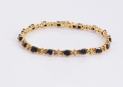 Lot 95 - A silver gilt sapphire set line bracelet