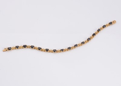 Lot 95 - A silver gilt sapphire set line bracelet