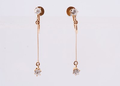 Lot 100 - A pair of yellow metal diamond drop earrings