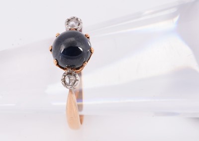Lot 105 - A cabochon sapphire & diamond three stone ring