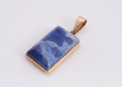 Lot 124 - A rectangle blue sodalite yellow metal framed pendant