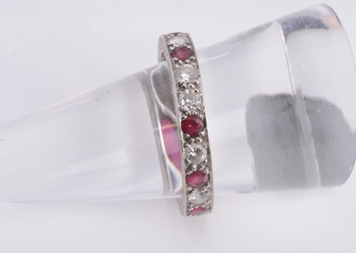 Lot 168 - A 18ct gold diamond & ruby eternity ring