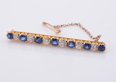 Lot 216 - A graduated sapphire & diamond bar brooch