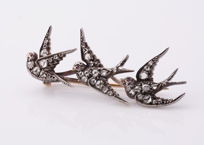 Lot 221 - A white metal three swallows in flight, diamond set brooch