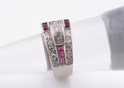 Lot 236 - An art deco ruby & diamond stylised buckle ring