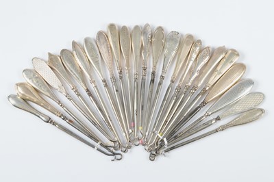 Lot 273 - Twenty four silver handled button hooks
