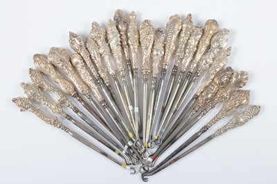Lot 278 - Twenty four silver handled button hooks