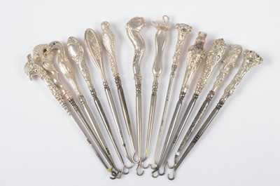 Lot 282 - Thirteen novelty silver handled button hooks