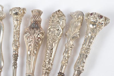 Lot 282 - Thirteen novelty silver handled button hooks