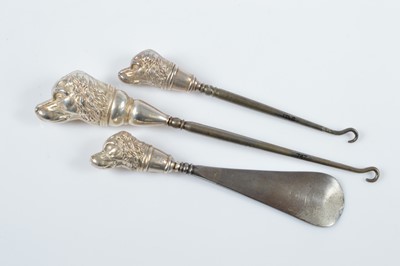 Lot 301 - Two novelty silver dog mask handled button hooks