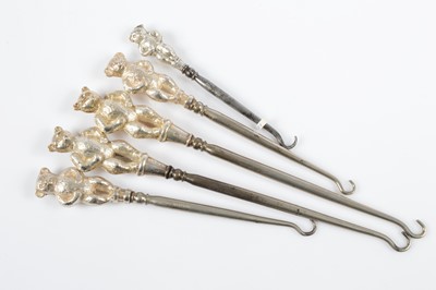 Lot 302 - Five novelty silver handled steel button hooks