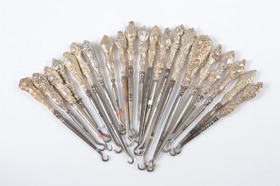 Lot 306 - A collection of silver handled embossed decorated steel button hooks