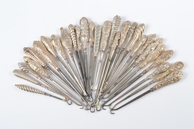 Lot 308 - A collection of art nouveau style silver handled button hooks