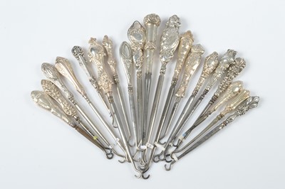 Lot 311 - A collection of silver handled art nouveau style and later steel button hooks