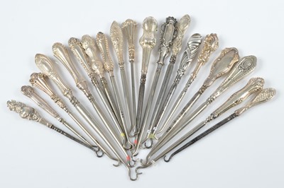 Lot 312 - A collection of silver handled steel button hooks