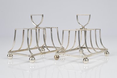 Lot 387 - A pair of Art Deco period silver toast racks by EJH NH