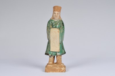 Lot 49 - A small Chinese pottery Sancai glazed Ming style attendant figure