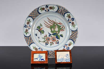 Lot 98 - A 19th century tin glazed earthenware charger and two framed sections of Dutch Delft tiles
