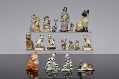 Lot 127 - A collection of ceramic pussy cats and porcelain figural group of a lady and cat